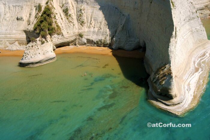 Cliffs and golden sands at Loggas Beach in Peroulades