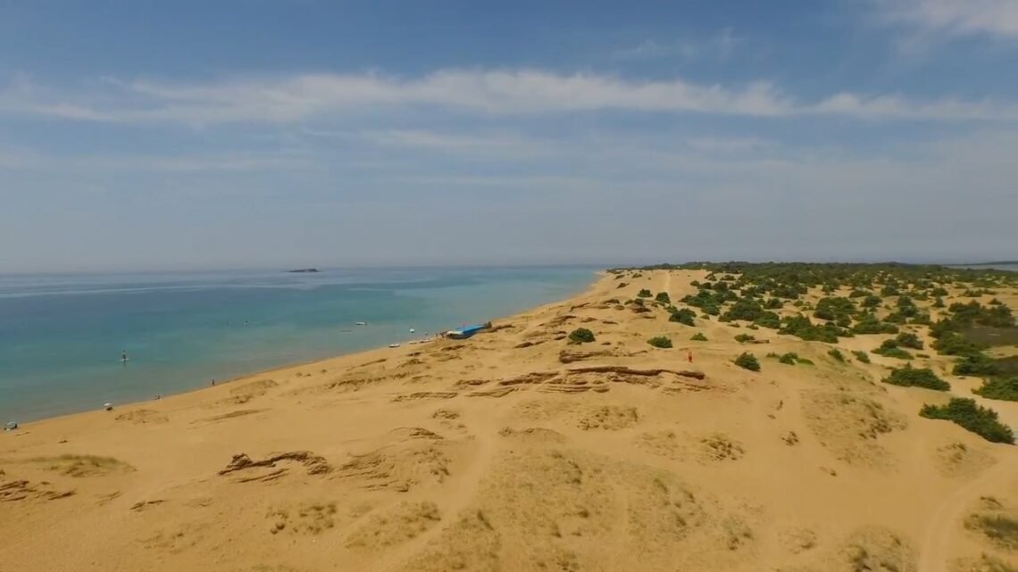 Issos beach view with a large dune in the middle
