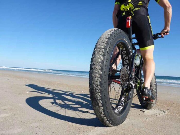 With a bike on the beach